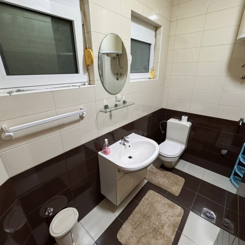 Modern Ulcinj bathroom: stylish beige & brown tiles, premium fixtures, ample storage&mdash;exclusive on immorenta.me by ekosphere doo.