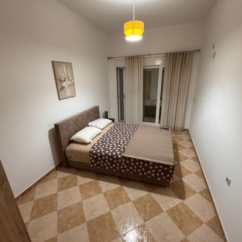 Bright Ulcinj bedroom with double bed, stylish d&eacute;cor, large glass doors, tiled floor&mdash;ideal Montenegro investment via immorenta.me.