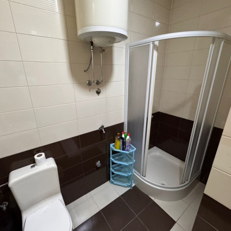 Modern bathroom featuring a glass corner shower, quality tiling, and essential amenities&mdash;prime Ulcinj investment via immorenta.me.