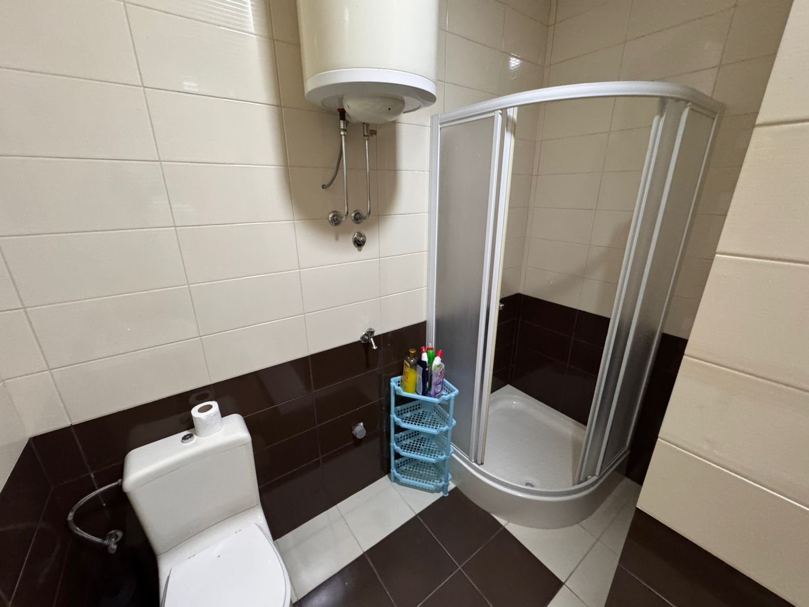 Modern bathroom featuring a glass corner shower, quality tiling, and essential amenities&mdash;prime Ulcinj investment via immorenta.me.