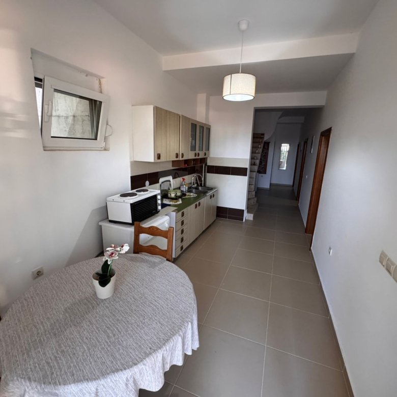 Charming Ulcinj kitchen with a modern layout, quality cabinets, dining nook, and bright hallway &mdash; exclusive at immorenta.me by ekosphere doo.