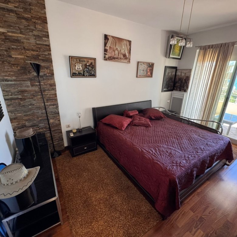 Modern Ulcinj bedroom with sea-view balcony, quality wood floors, elegant double bed&mdash;ideal Montenegro investment at immorenta.me.