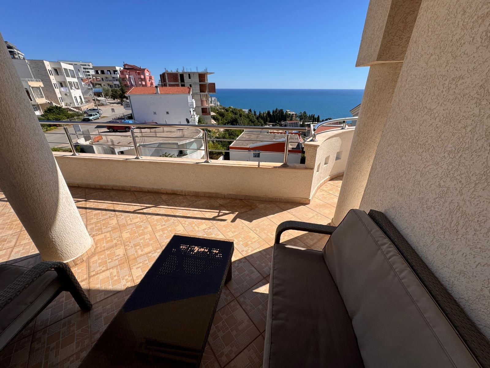 Luxury tiled balcony in Ulcinj with sea view, modern outdoor lounge, and prime investment appeal. Montenegro-listings.me by ekosphere doo.