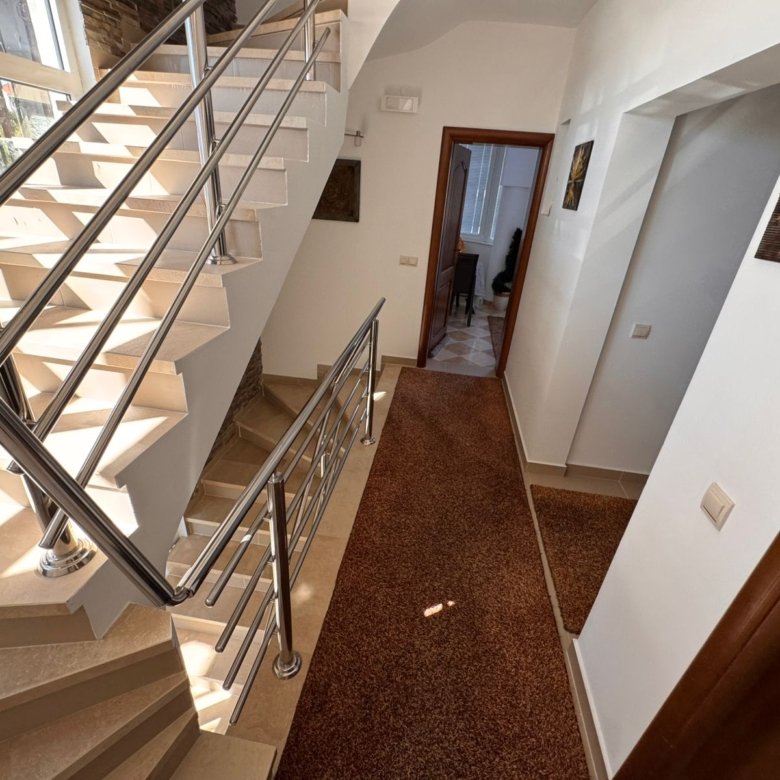 Showcasing a sunlit Ulcinj hallway with modern beige stairs, premium finishes, and investment potential via immorenta.me by ekosphere doo.