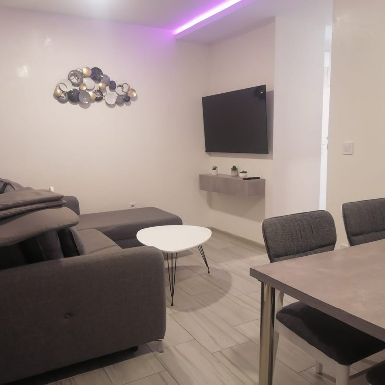 Stunning Ulcinj property: modern living room, chic gray sectional, sleek dining set, stylish d&eacute;cor&mdash;exclusive on Montenegro-Listings.me by ekosphere doo.