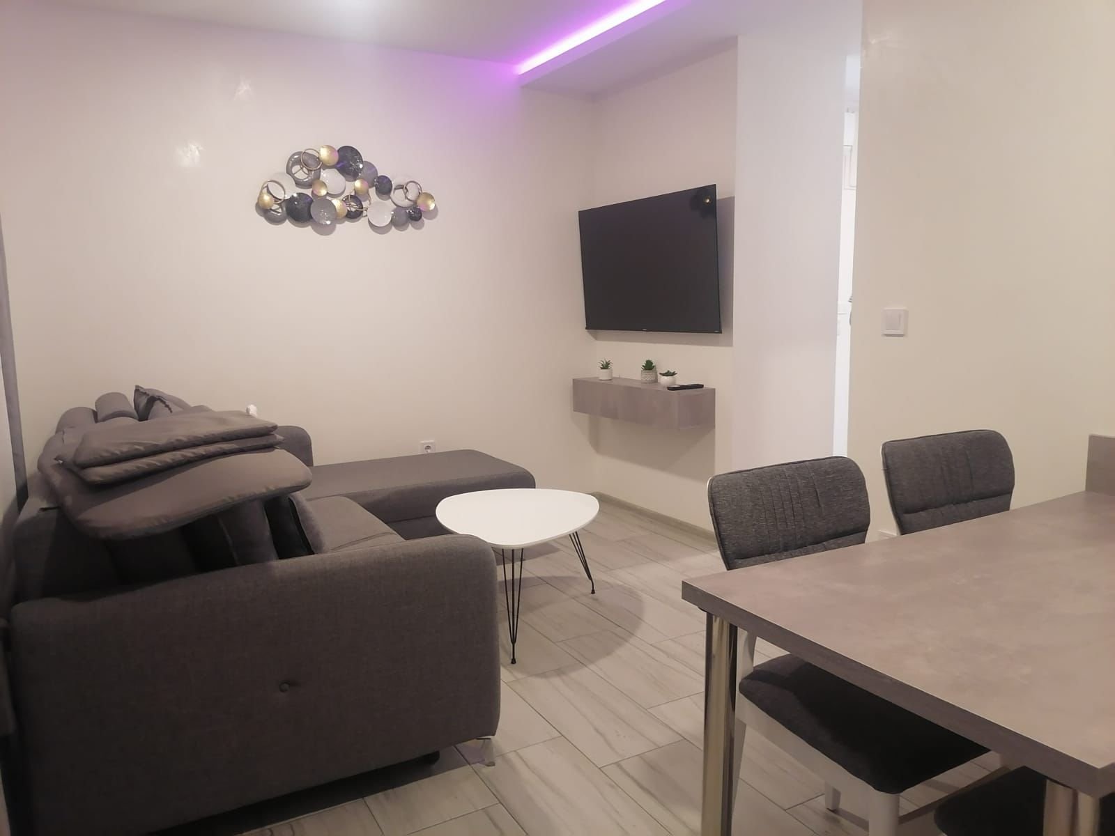 Stunning Ulcinj property: modern living room, chic gray sectional, sleek dining set, stylish d&eacute;cor&mdash;exclusive on Montenegro-Listings.me by ekosphere doo.