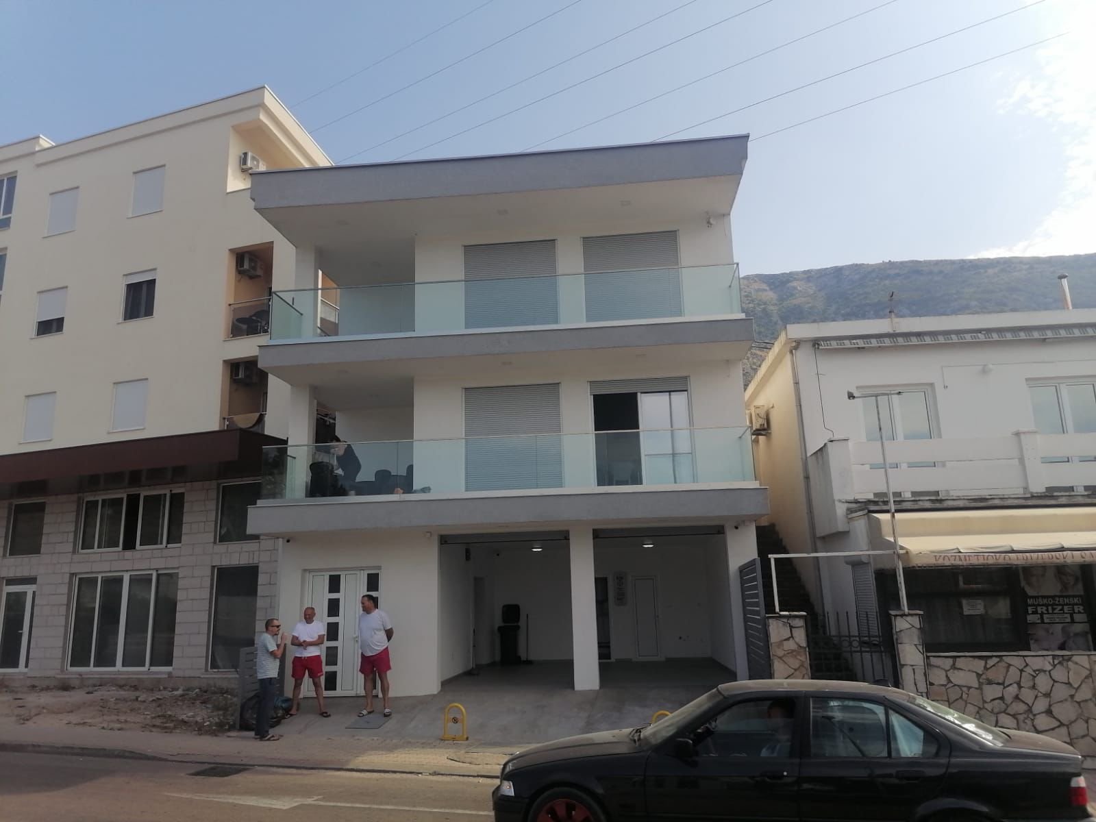 Sleek three-story Ulcinj building with glass balconies, ground-floor garage, and prime street location&mdash;exclusively on immorenta.me by ekosphere doo.