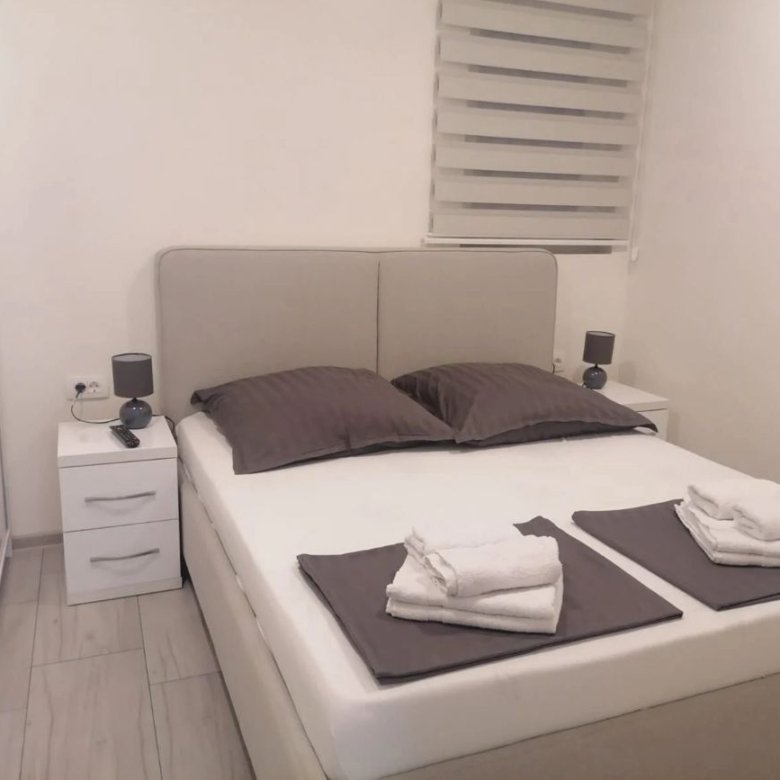 Modern Ulcinj bedroom with double bed, stylish d&eacute;cor, tile floors, and natural light&mdash;exclusive on immorenta.me by ekosphere doo.