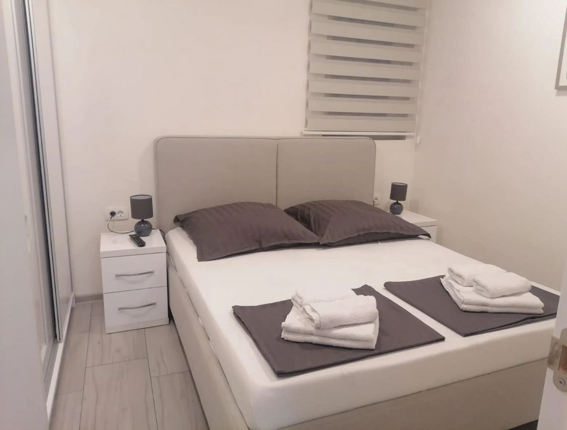 Modern Ulcinj bedroom with double bed, stylish d&eacute;cor, tile floors, and natural light&mdash;exclusive on immorenta.me by ekosphere doo.