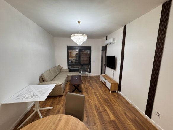 Elegant Ulcinj apartment: modern living room, wood floors, AC, dining area. Invest in Montenegro at immorenta.me by ekosphere doo.