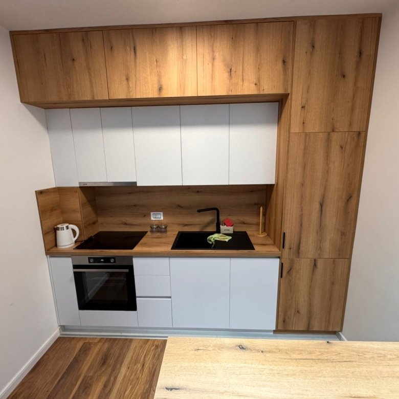 Stylish Ulcinj kitchen: wood & white cabinets, built-in oven, modern finishes&mdash;exclusive to immorenta.me by ekosphere doo.