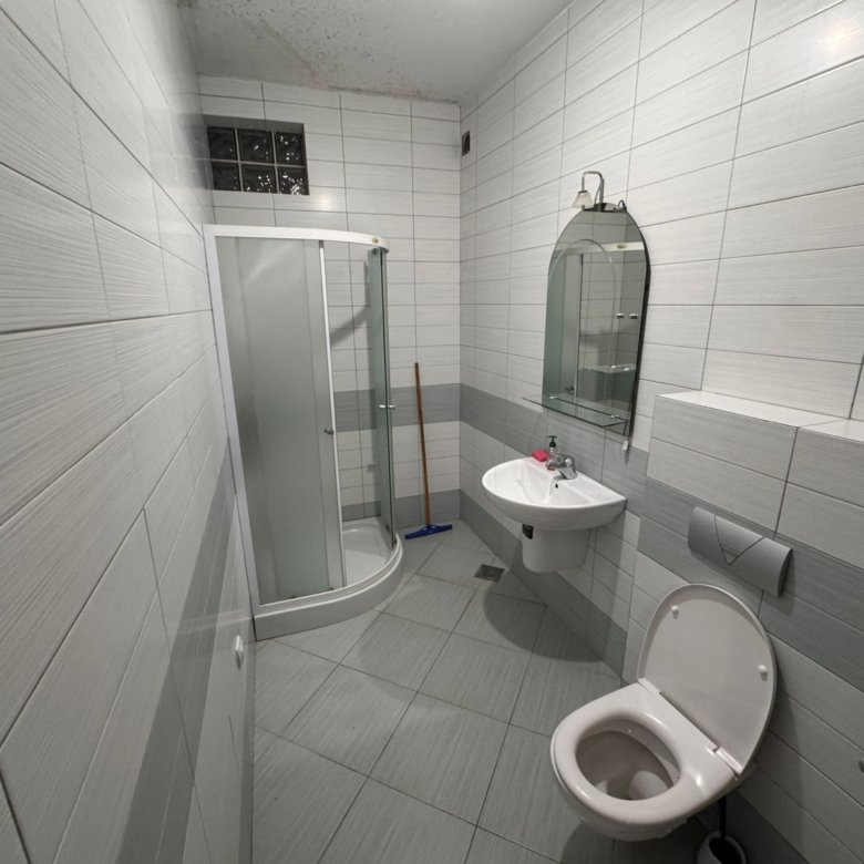 Modern gray-tiled bathroom with glass shower, wall-mount sink, and premium fixtures&mdash;exclusive Ulcinj investment via immorenta.me by ekosphere doo.