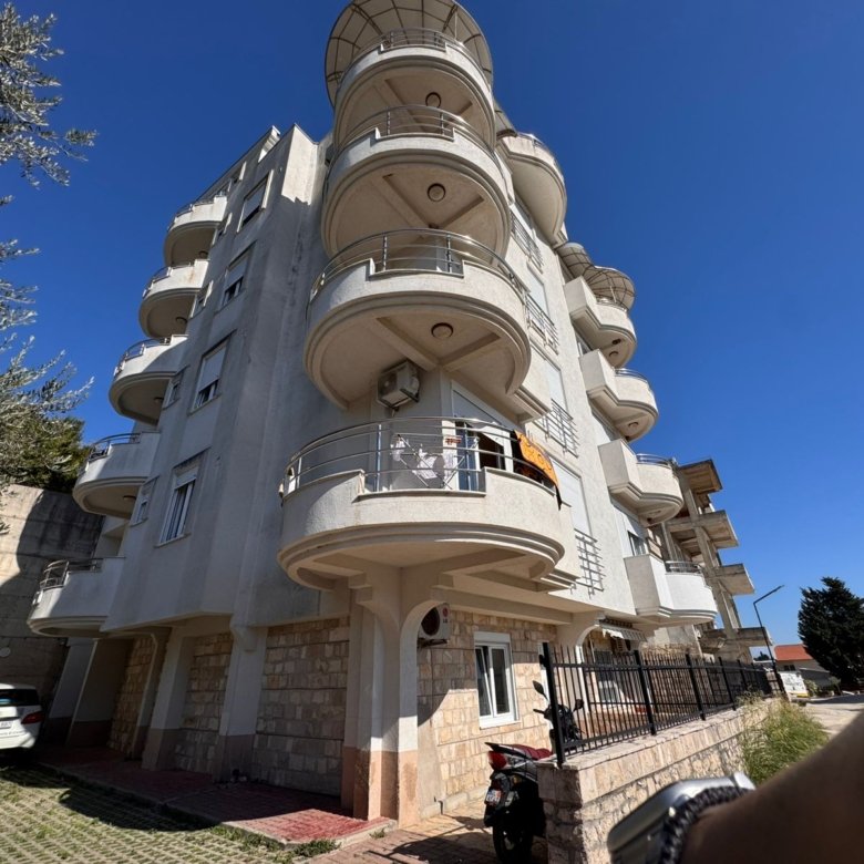 Modern multi-story residence in Ulcinj, Montenegro: curved balconies, white facade, parking. Exclusive on immorenta.me by ekosphere doo.