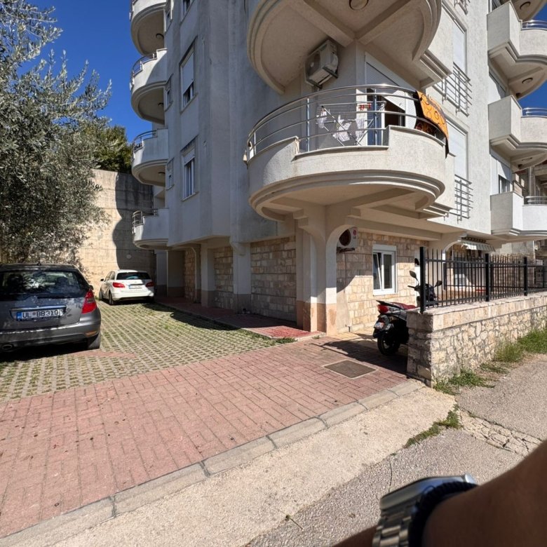 Modern multi-story Ulcinj apartment with curved balconies, tiled parking, and strong investment appeal at immorenta.me.
