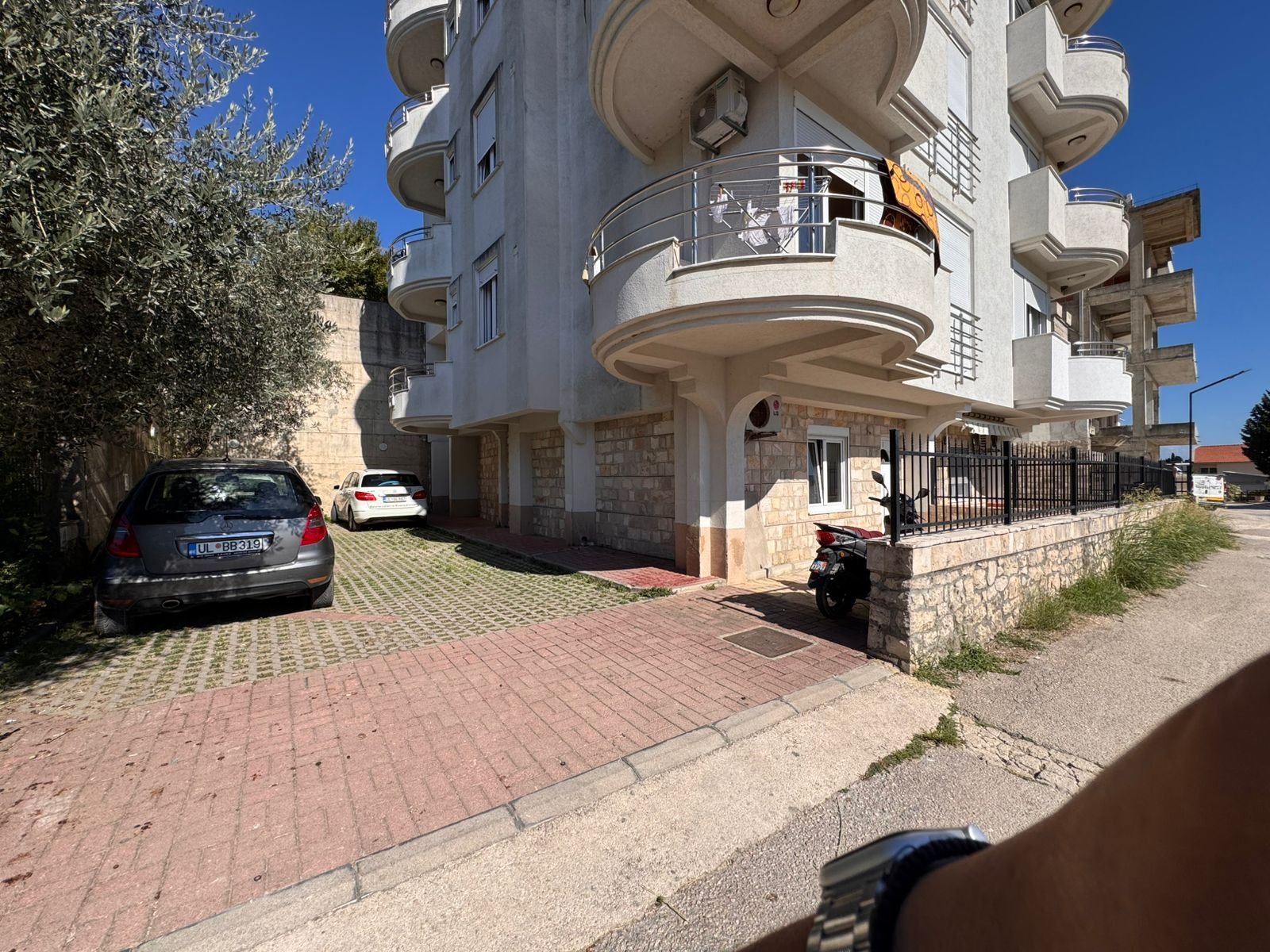 Modern multi-story Ulcinj apartment with curved balconies, tiled parking, and strong investment appeal at immorenta.me.
