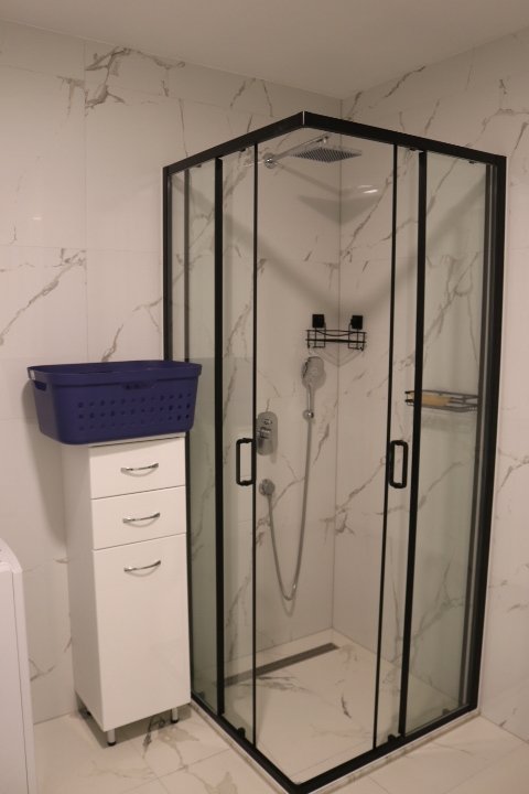 Discover a stylish Ulcinj bathroom with marble walls, glass shower, premium fixtures&mdash;exclusive at immorenta.me by ekosphere doo.