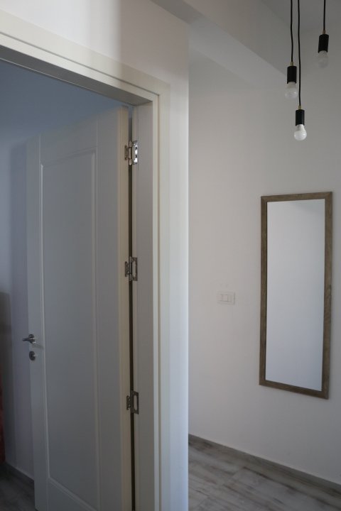 Step into this modern Ulcinj apartment: sleek gray wood floors, elegant lighting, and quality finishes. See more on immorenta.me by ekosphere doo.