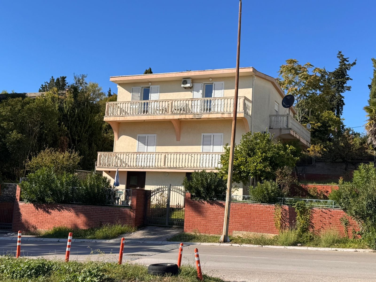 Stunning three-story house in Ulcinj, Montenegro. Balconies, lush greenery, ideal investment. See more at immorenta.me.