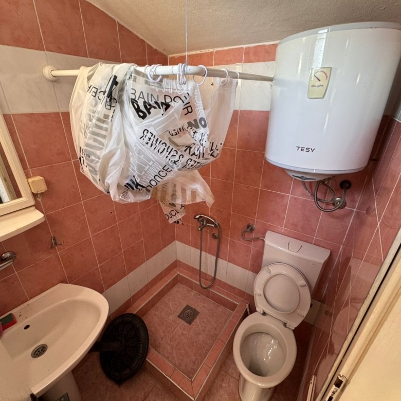 Modern bathroom in Ulcinj, Montenegro: pink & white tiles, bidet shower, water heater, ideal investment. eksophere doo project.