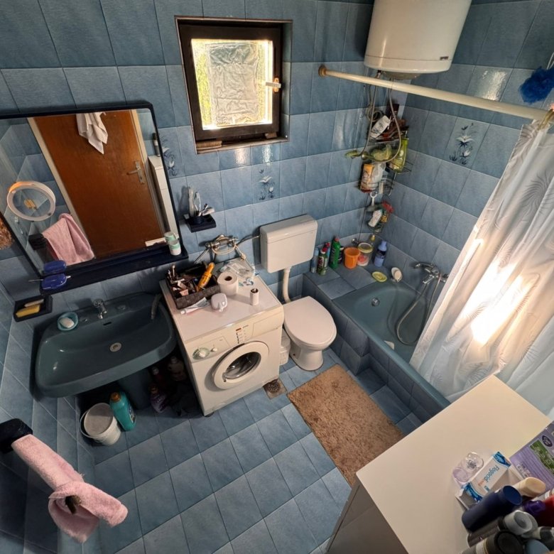 Modern blue-tiled bathroom in Ulcinj with quality fixtures, ideal investment property. Exclusive at immorenta.me by ekosphere doo.