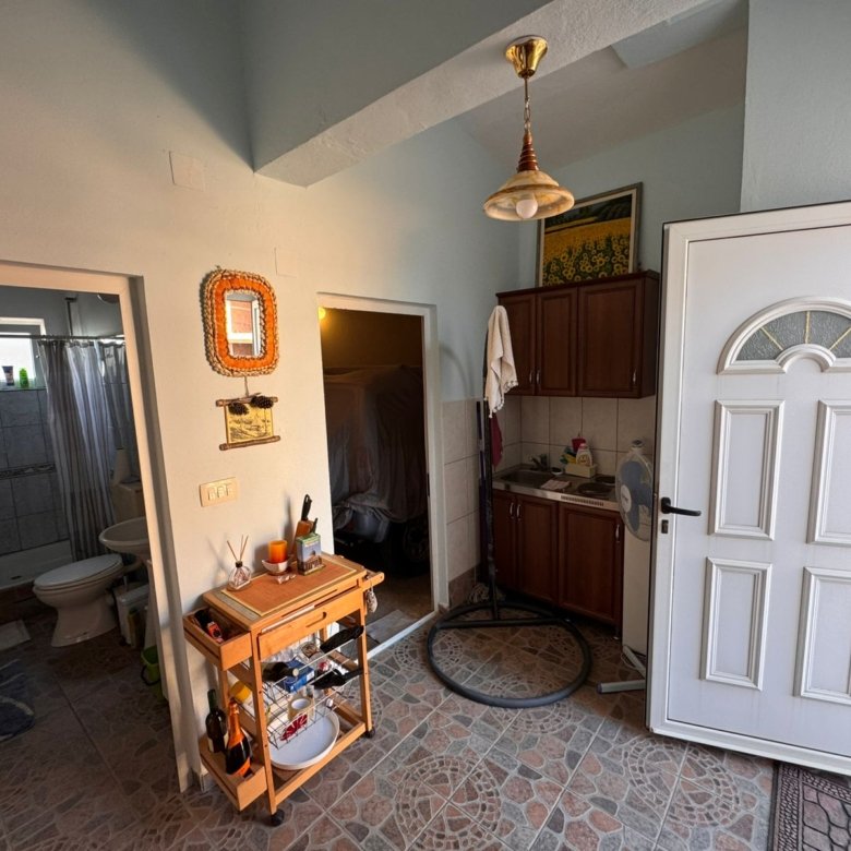 Bright entryway with tiled floors, modern white door, bathroom access, and versatile storage&mdash;ideal Ulcinj investment via immorenta.me.