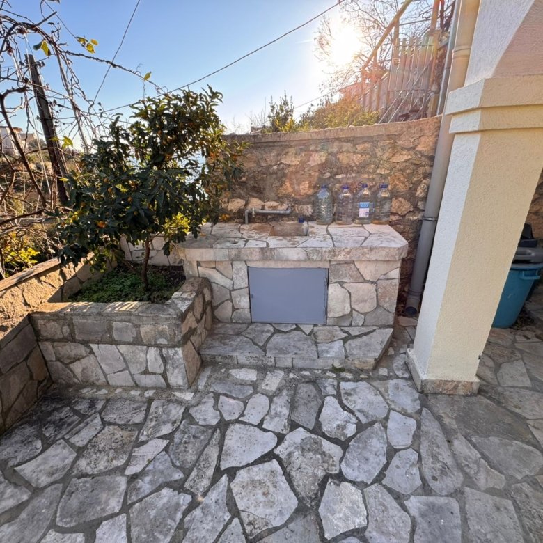 Stunning stone outdoor sink on a sunlit patio in Ulcinj, Montenegro&mdash;ideal investment. Montenegro-listings.me by ekosphere doo.