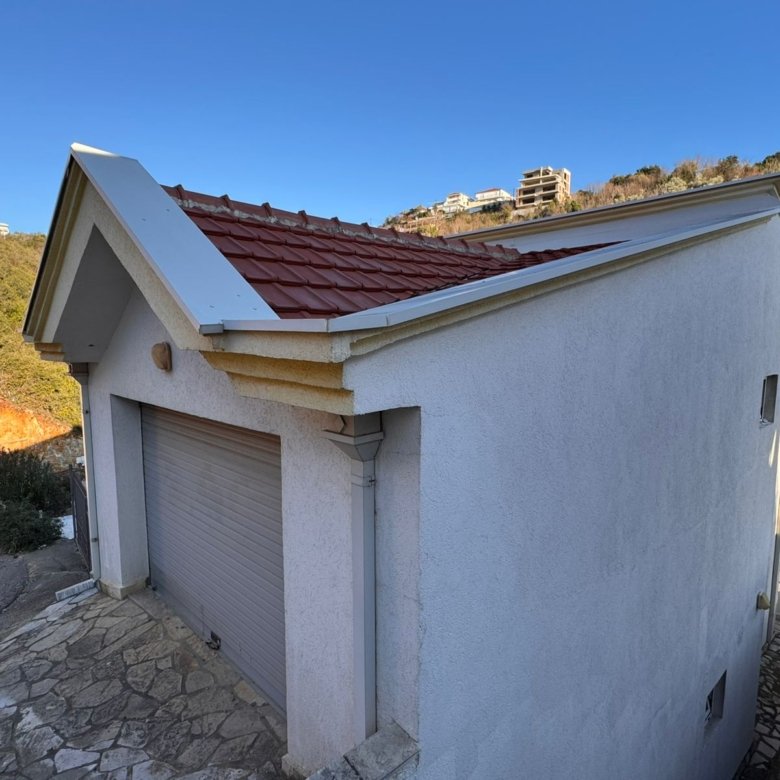 Charming white home with red-tiled roof, stone driveway, and garage in scenic Ulcinj hills. Exclusive at immorenta.me by ekosphere doo.