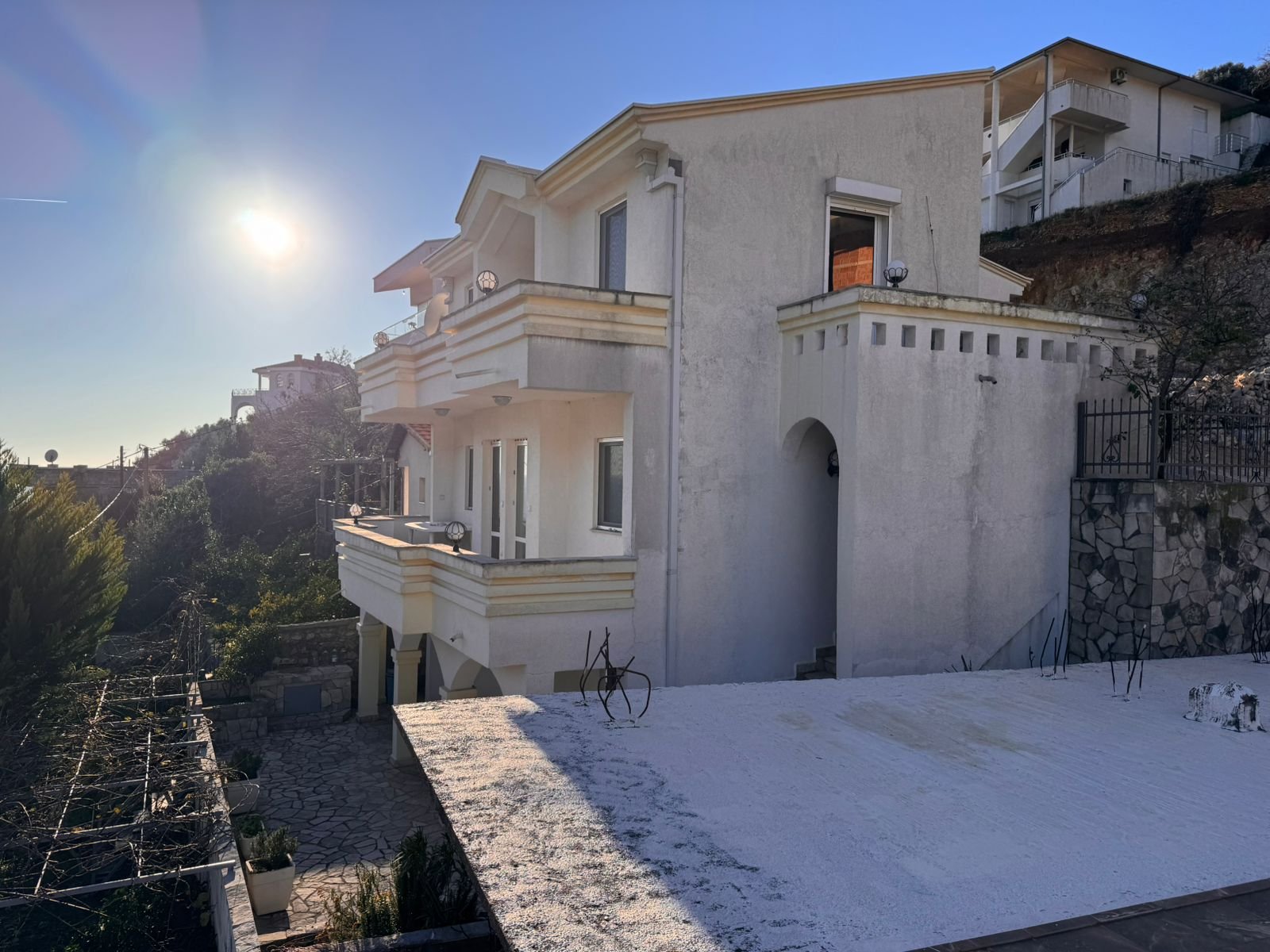 Modern two-story white villa with balconies, flat roof, and hillside views in Ulcinj, Montenegro&mdash;ideal investment. eksosphere doo.
