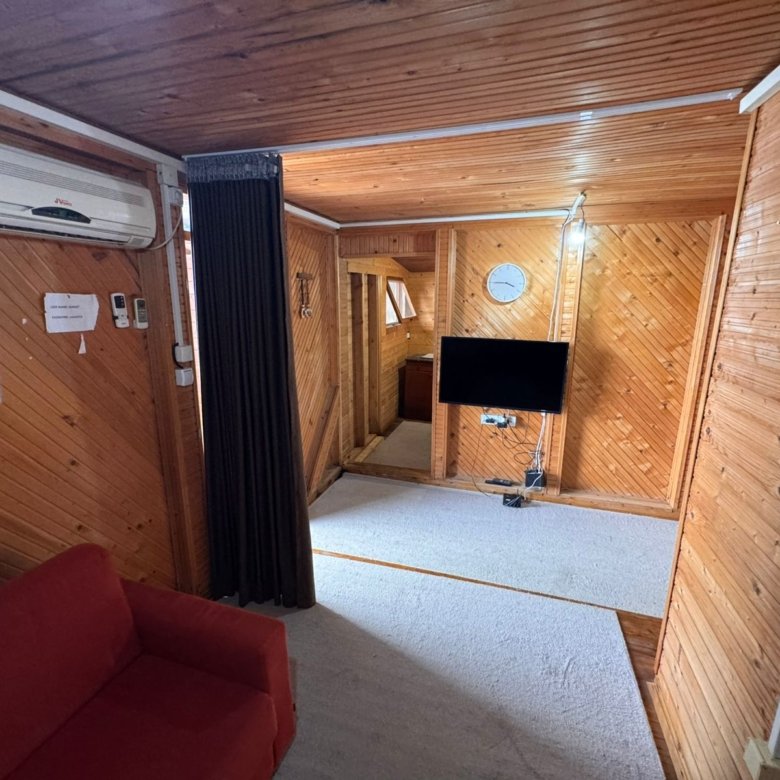 Charming Ulcinj apartment with wood paneling, red sofa, AC, wall TV&mdash;ideal Montenegro investment. Listed by ekosphere doo.