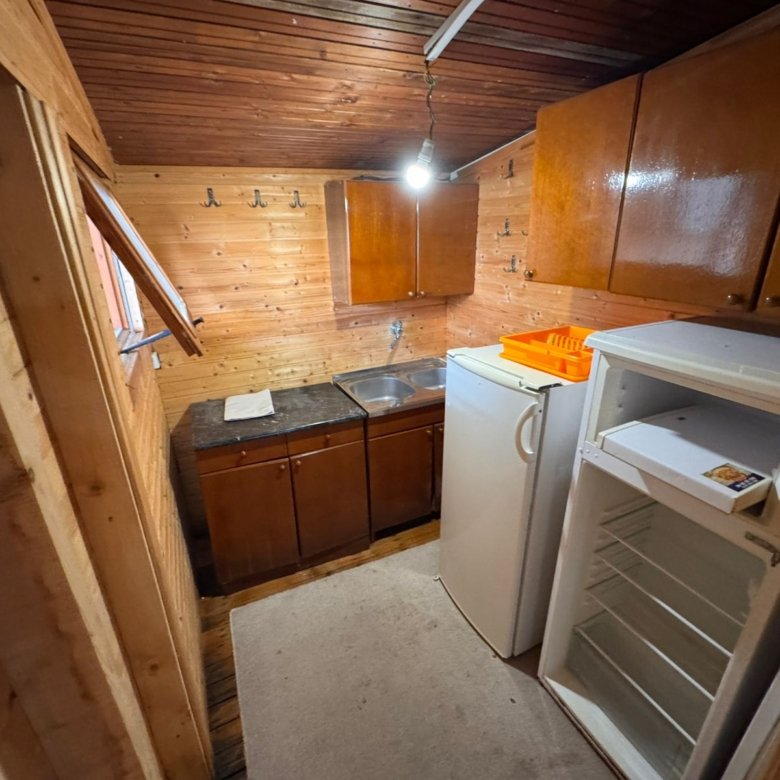 Charming Ulcinj kitchen with wooden finishes, modern fixtures, fridge, and ample storage&mdash;ideal Montenegro investment from ekosphere doo.