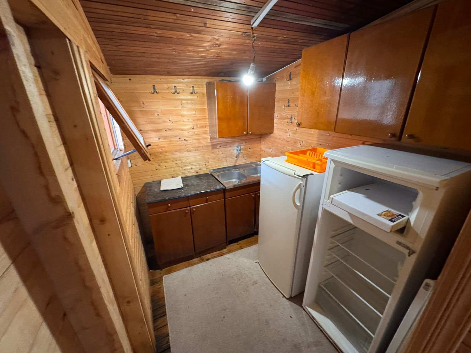 Charming Ulcinj kitchen with wooden finishes, modern fixtures, fridge, and ample storage&mdash;ideal Montenegro investment from ekosphere doo.