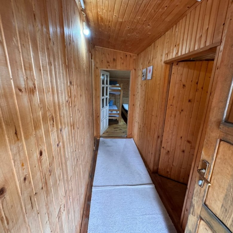 Elegant wooden hallway with premium finishes, white carpets, and cozy bunk beds&mdash;exclusive Ulcinj listing at immorenta.me.