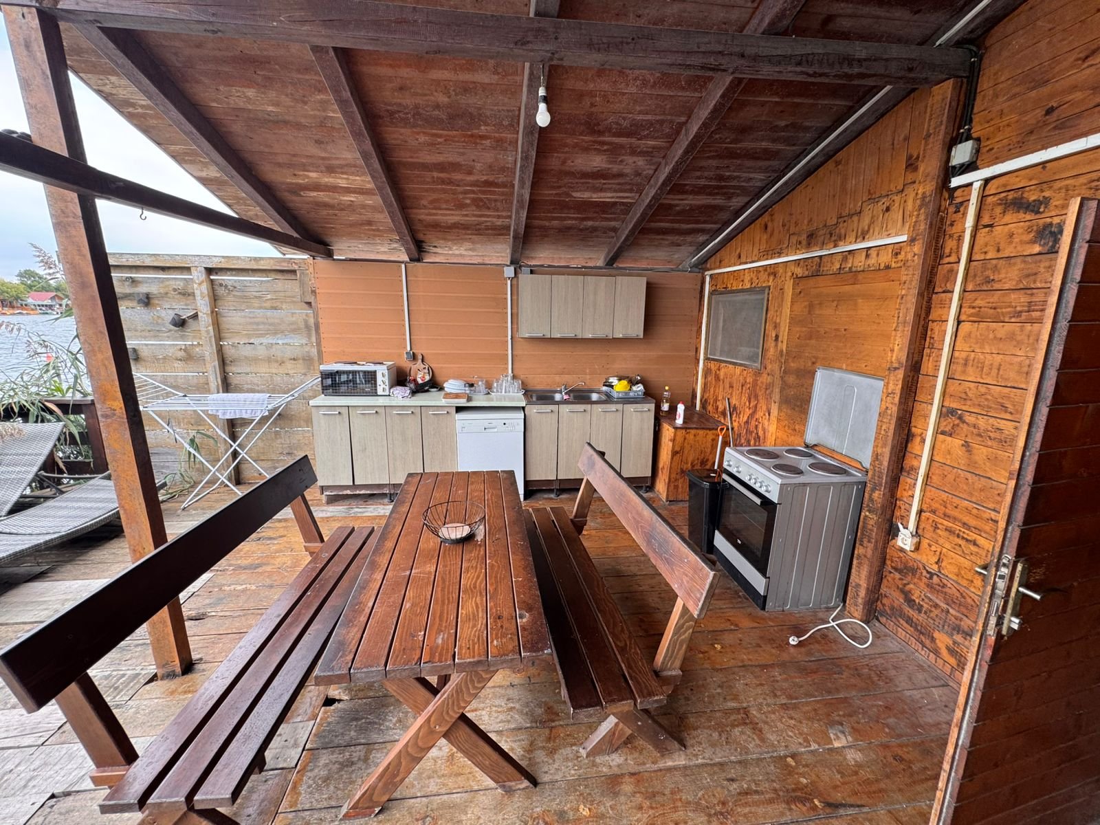 Charming rustic outdoor kitchen in Ulcinj with wood floors, dining set, appliances&mdash;ideal Montenegro investment. On immorenta.me.