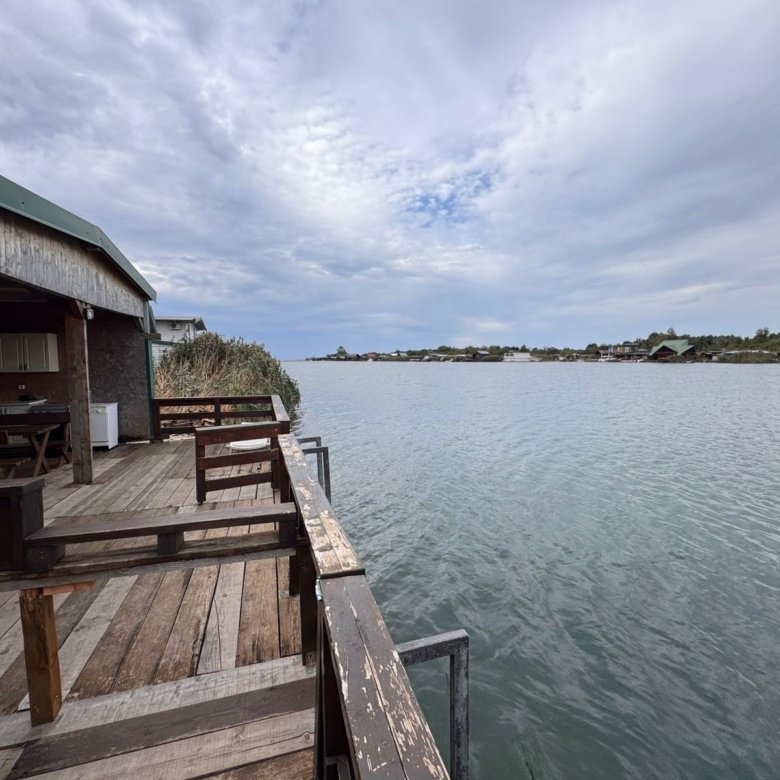 Stunning waterfront deck in Ulcinj, Montenegro&mdash;ideal investment with serene views, benches, and close to shoreline homes. Listed by ekosphere doo.