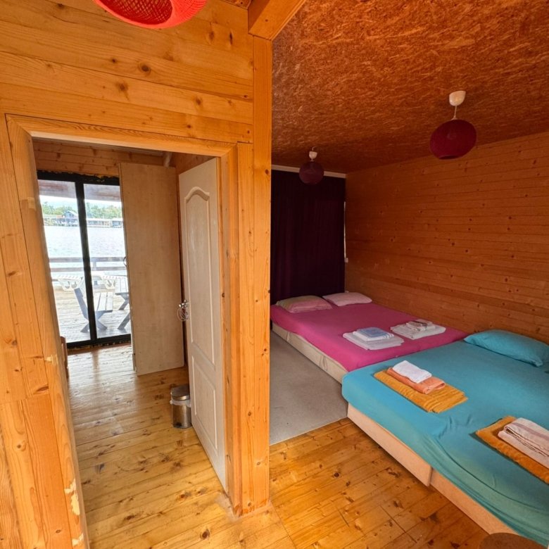 Charming Ulcinj wooden cabin with open-plan interior, twin beds, vibrant bedding, scenic views&mdash;exclusive on immorenta.me by ekosphere doo.