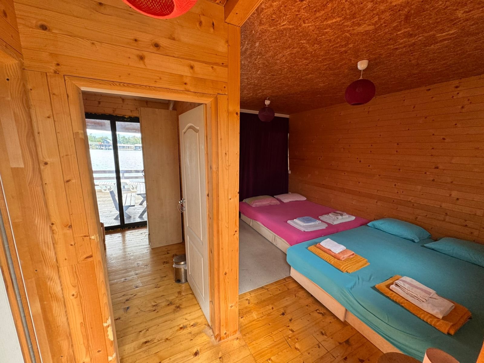 Charming Ulcinj wooden cabin with open-plan interior, twin beds, vibrant bedding, scenic views&mdash;exclusive on immorenta.me by ekosphere doo.