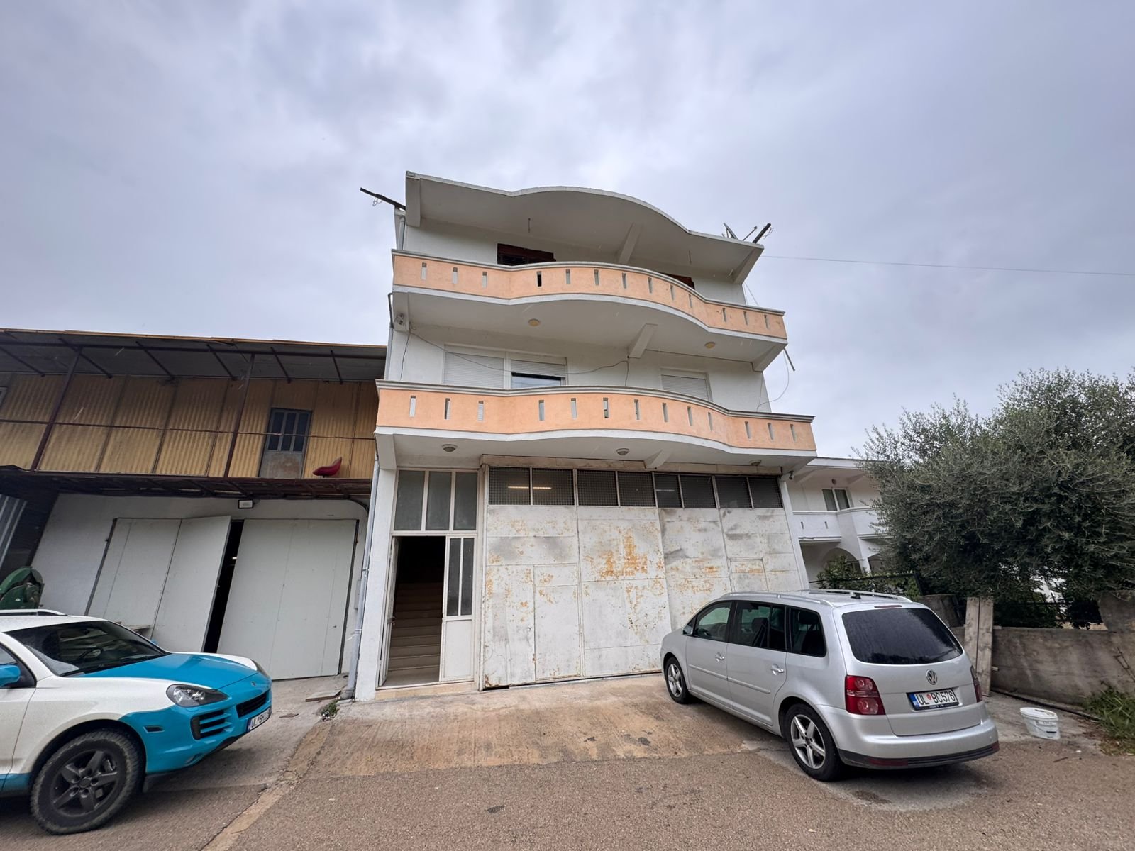 Stunning three-story peach & white building with large balconies in Ulcinj. Prime investment at immorenta.me by ekosphere doo.