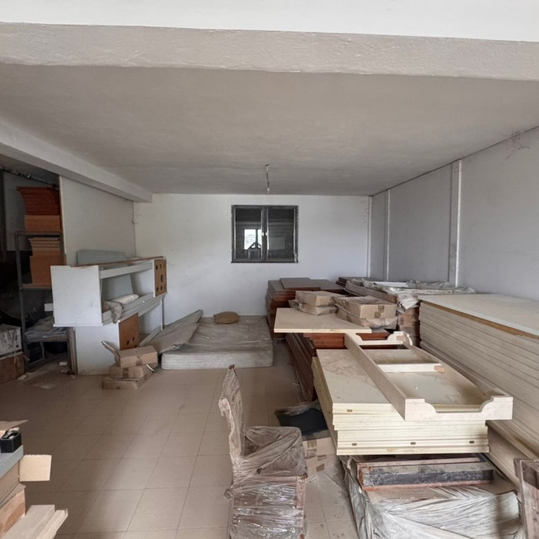 Spacious tiled storage room in Ulcinj, ideal for investment. Secure window, shelves, and ample space. See more at immorenta.me by ekosphere doo.