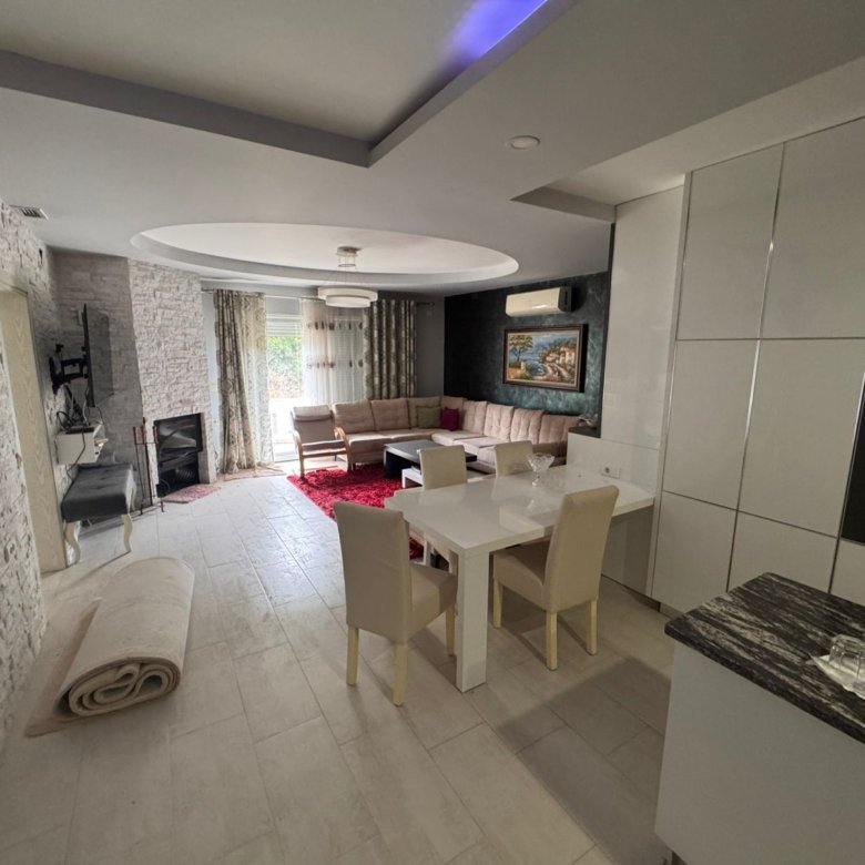 Bright, modern Ulcinj apartment: open-plan living/dining, stylish white tiles, large windows. Exclusive on immorenta.me by ekosphere doo.