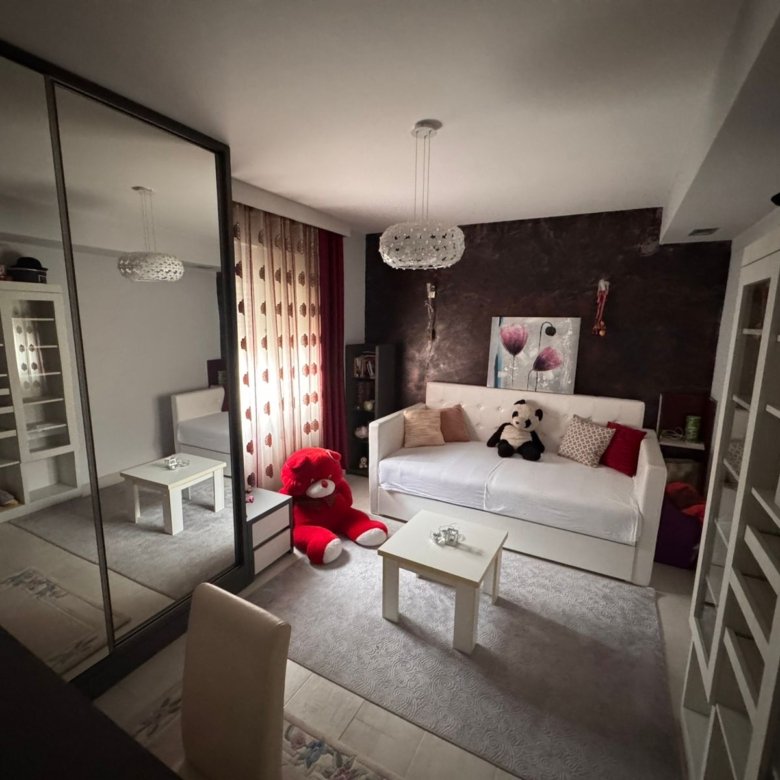 Stylish Ulcinj apartment: bright room, white sofa, mirrored closets, bookshelves&mdash;ideal Montenegro investment from ekosphere doo.
