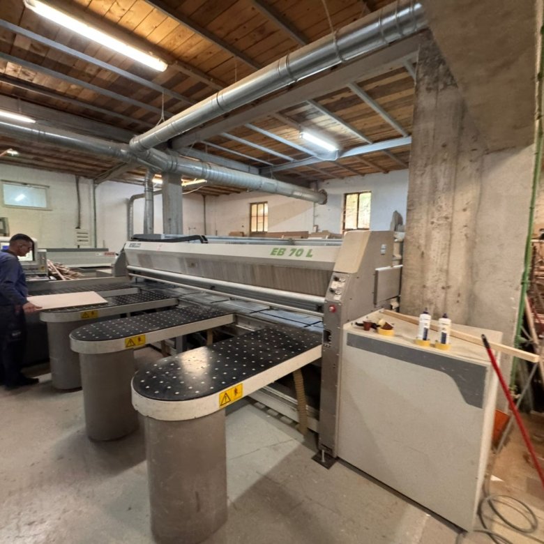 Spacious Ulcinj workshop with robust industrial saw, timber stacks, and wood-beamed ceilings&mdash;prime investment by ekosphere doo.