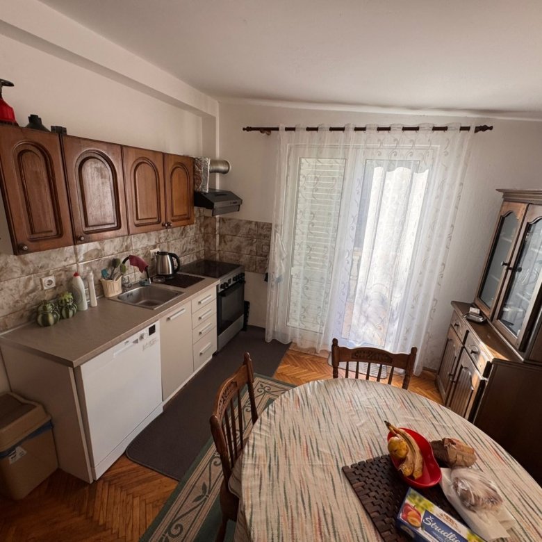 Modern Ulcinj kitchen with quality wood cabinetry, dining area, AC, and natural light&mdash;ideal investment via immorenta.me by ekosphere doo.