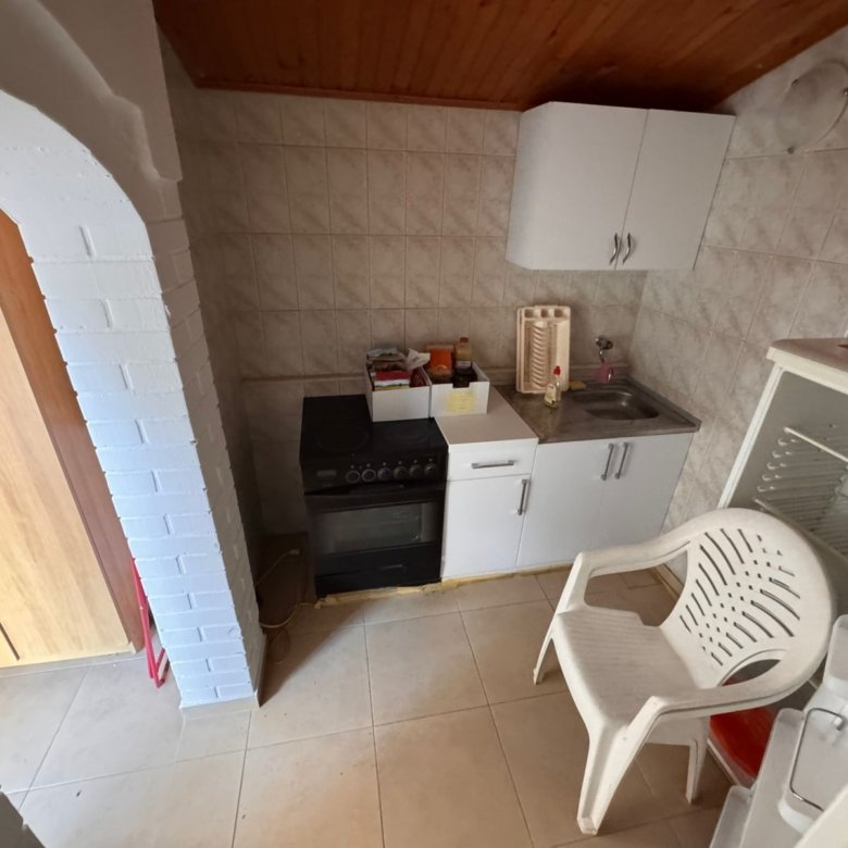 Modern small kitchen in Ulcinj: tiled walls, wood ceiling, archway. Investment-ready, exclusive on immorenta.me by Ekosphere DOO.