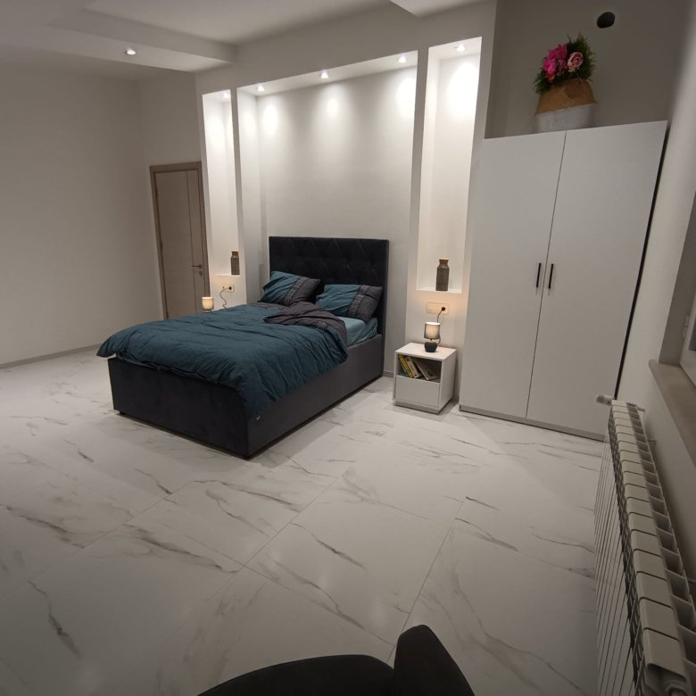 Modern Ulcinj bedroom with marble floors, elegant teal-accented bed, and premium finishes&mdash;exclusive from ekosphere doo on immorenta.me.