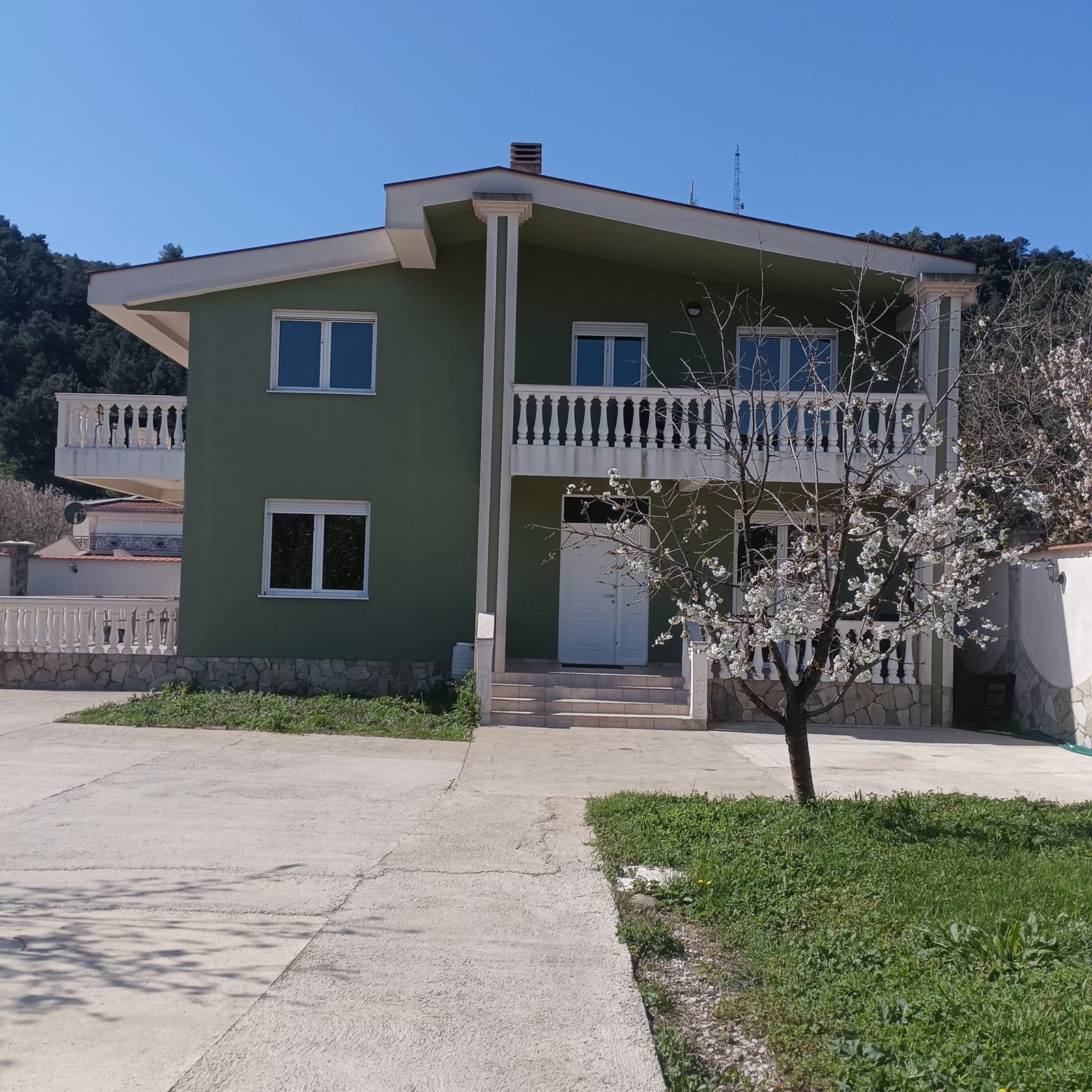 Charming two-story green home in Ulcinj, Montenegro with balcony, lush yard, and scenic views. Exclusive at immorenta.me by ekosphere doo.