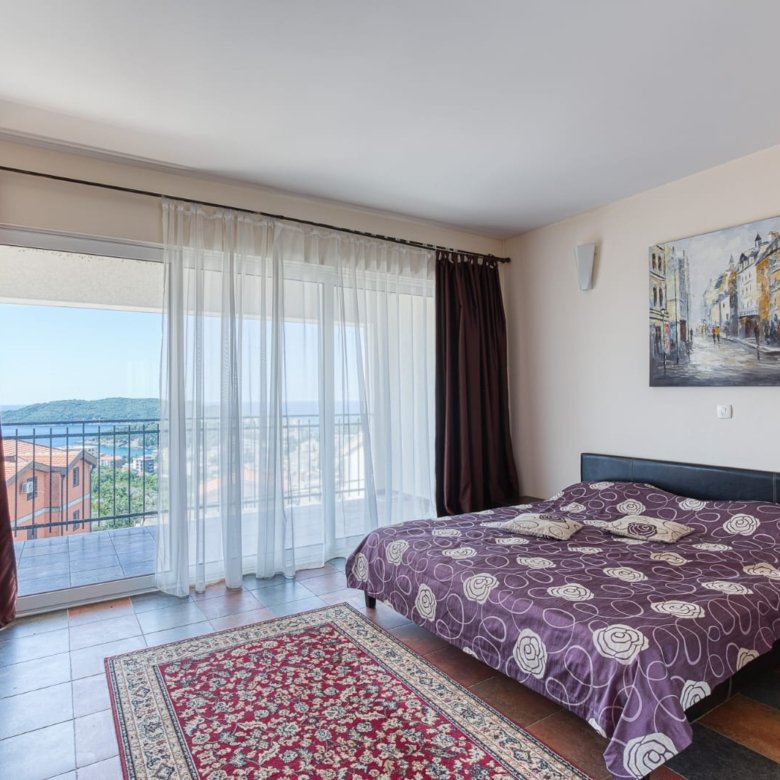 Elegant Ulcinj bedroom with double bed, modern decor, full-length windows, private balcony&mdash;prime real estate via immorenta.me.