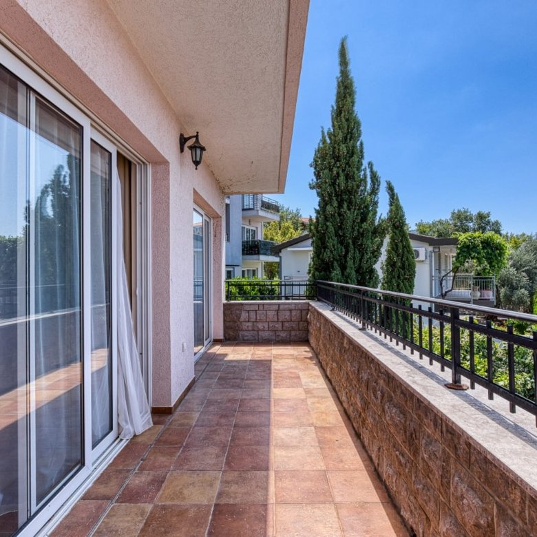 Spacious tiled balcony with metal railing, large glass doors, and scenic Ulcinj views&mdash;prime property via immorenta.me by ekosphere doo.