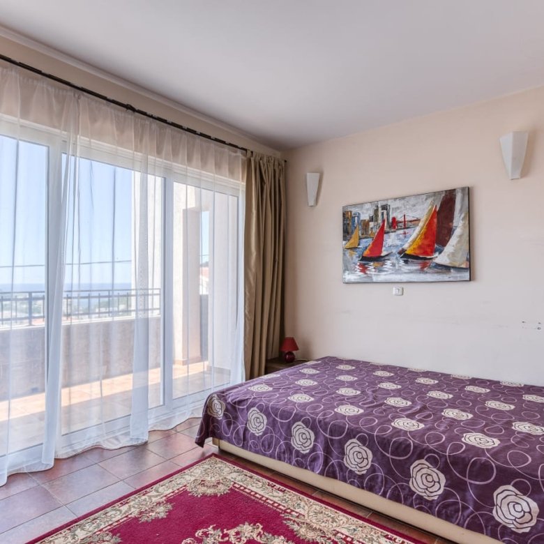 Spacious Ulcinj bedroom with natural light, balcony access, stylish d&eacute;cor. Invest in Montenegro real estate at immorenta.me.