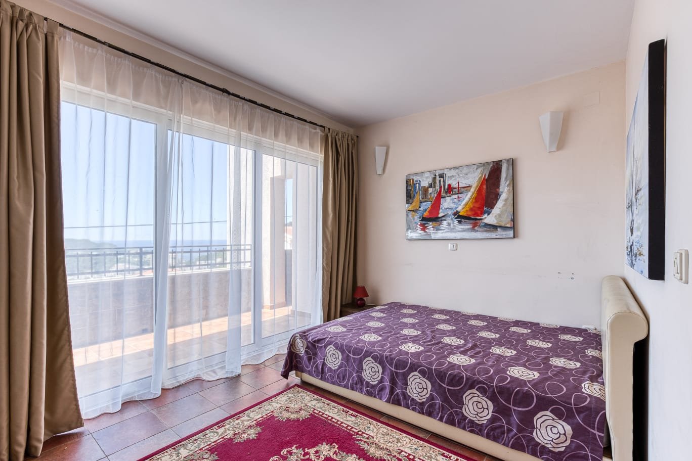 Spacious Ulcinj bedroom with natural light, balcony access, stylish d&eacute;cor. Invest in Montenegro real estate at immorenta.me.