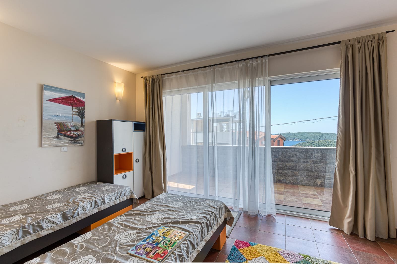 Bright Ulcinj bedroom with twin beds, balcony access, stylish decor&mdash;ideal Montenegro real estate from immorenta.me by ekosphere doo.